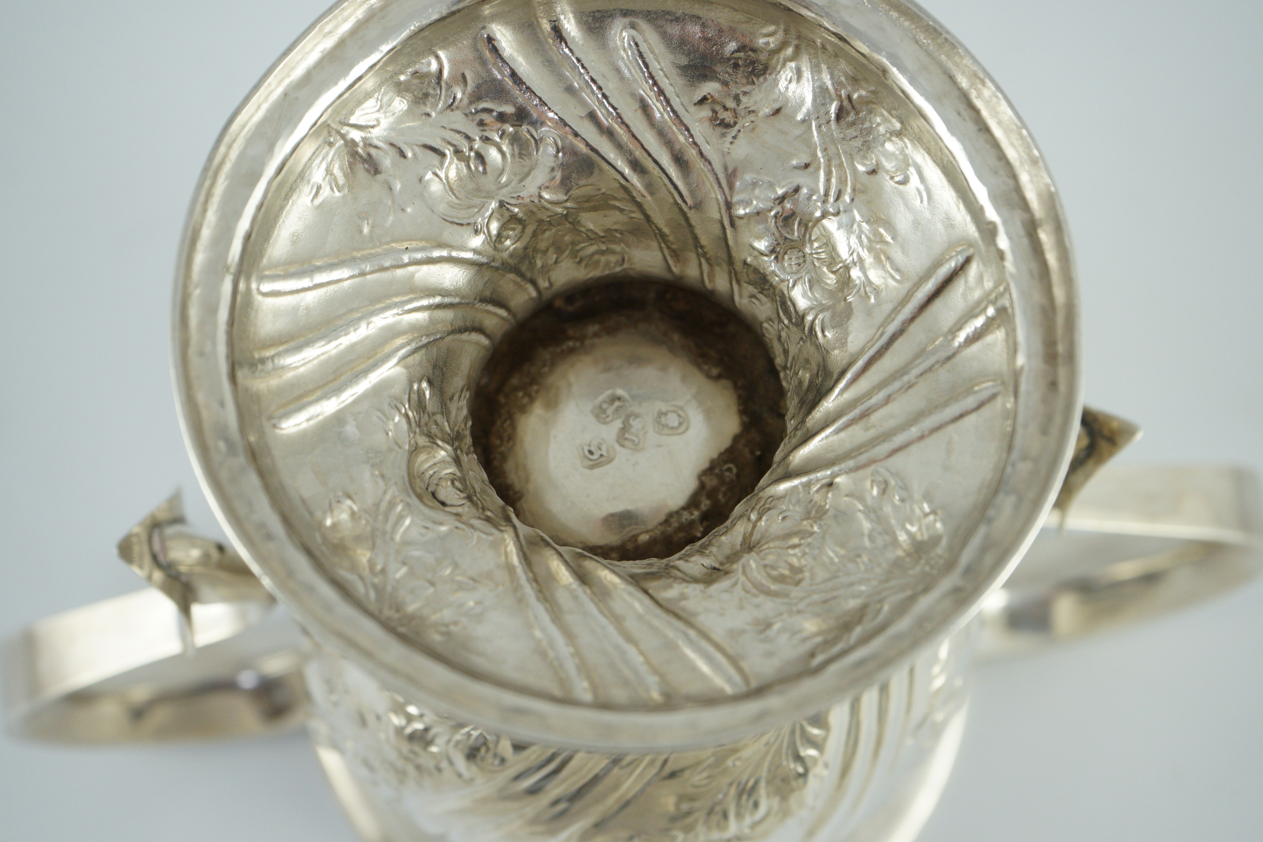 A George III silver baluster two handled pedestal cup, with later embossed decoration, by John Scofield